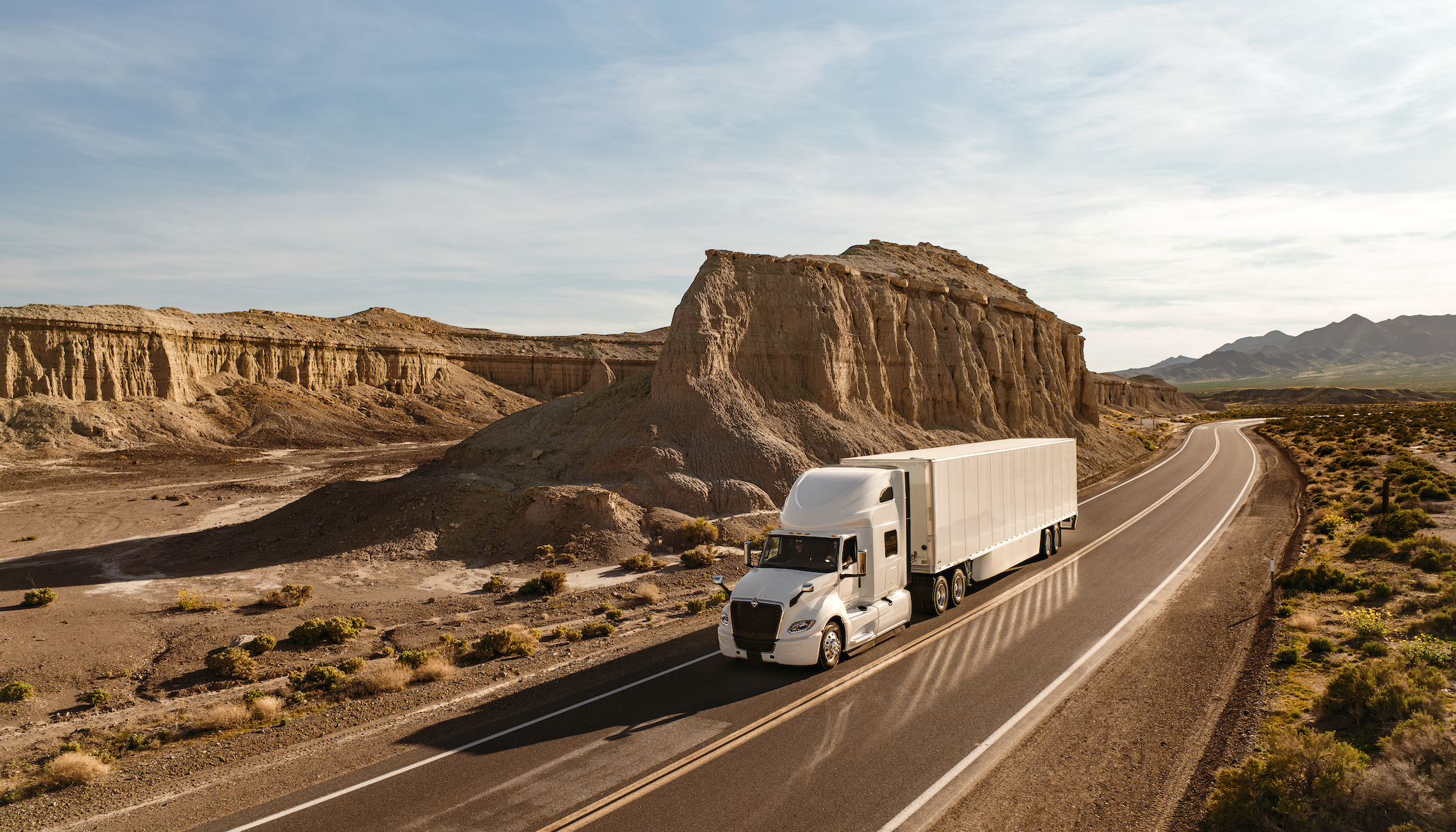 International Lt Driving Around A Mountain In Desert