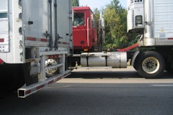 Red Truck Between Two Trailers