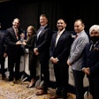 From left: Steve Williams, Interstate Billing; TPS Editor Lucas Deal; Melissa Larson, TLG; Mike Headley, TLG; Rodrigo Piccini, Procede; Craig O'Hare, National Truck Protection; and Harjeev Khanduja, Automann; recognize TLG as the winner of the 2025 Successful Dealer Award Tuesday during an awards banquet in Nashville.