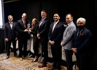 From left: Steve Williams, Interstate Billing; TPS Editor Lucas Deal; Melissa Larson, TLG; Mike Headley, TLG; Rodrigo Piccini, Procede; Craig O'Hare, National Truck Protection; and Harjeev Khanduja, Automann; recognize TLG as the winner of the 2025 Successful Dealer Award Tuesday during an awards banquet in Nashville.