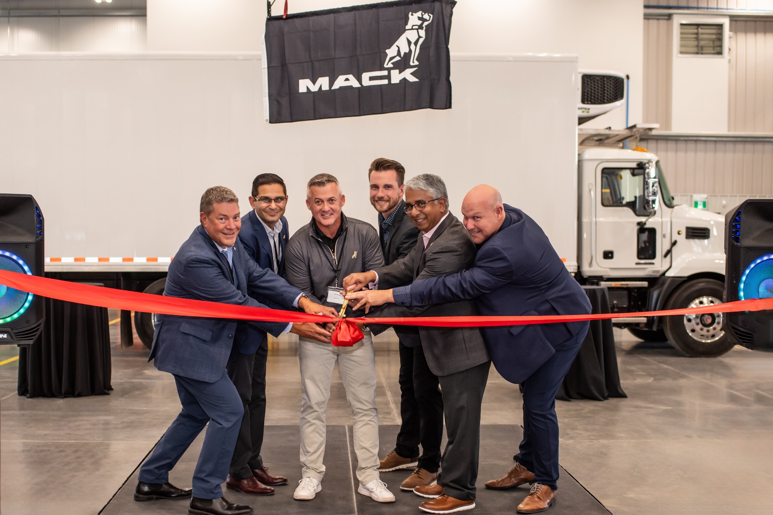 TransWestern Truck Centres relocated and opened a new full-service facility in Southeast Calgary, Alberta, Canada, Mack Trucks announced. Chris Gossler, left, Mack's vice president of channel development; Manish Sharma, service manager for TransWestern Truck Centres; Matt Davison, senior vice president of distribution and development; Luke Behnke, sales manager for TransWestern; Govi Kannan, Mack global product owner; and Wayne McDonald, Mack regional vice president for Canada.