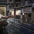 Man Looking At Parts In Storage