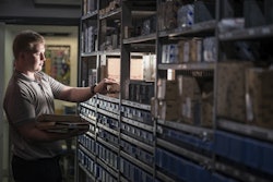 Man Looking At Parts In Storage