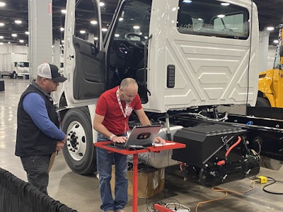 A competitor works on a repair while a judge looks on during the 2025 Rush Tech Skills Rodeo in Nashville.