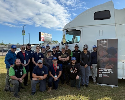 Pinellas Technical College instructors and students pose with a decommissioned truck donated to the diesel technician program by the MITER Foundation.