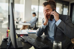 Frustrated Man On Phone And Computer