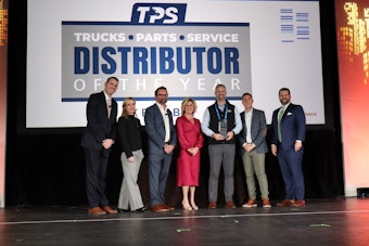 Truck Equipment Inc. President Matt Schroeder (center) is presented the 2025 TPS Distributor of the Year during the opening general session at Heavy Duty Aftermarket Week Tuesday in Grapevine, Texas.