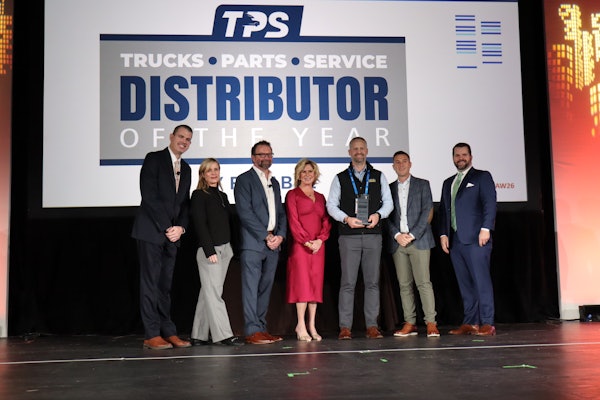Truck Equipment Inc. President Matt Schroeder (center) is presented the 2025 TPS Distributor of the Year during the opening general session at Heavy Duty Aftermarket Week Tuesday in Grapevine, Texas.