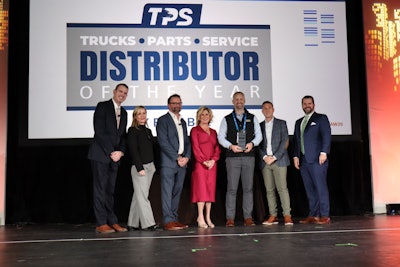 Truck Equipment Inc. President Matt Schroeder (center) is presented the 2025 TPS Distributor of the Year during the opening general session at Heavy Duty Aftermarket Week Tuesday in Grapevine, Texas.
