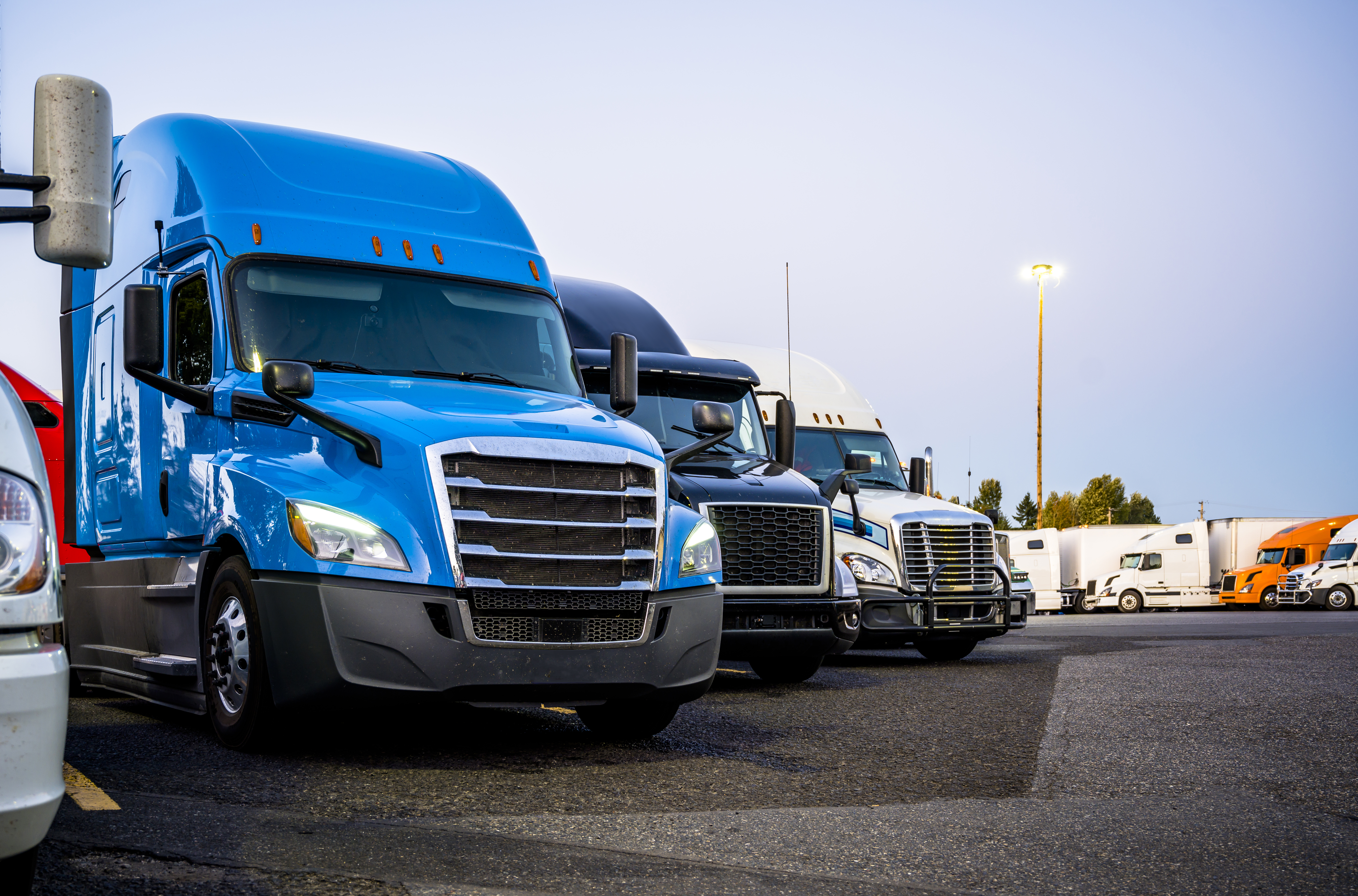 Line Of Trucks In Row Starting With Blue Truck
