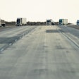 Trucks On Highway With Pavement In View