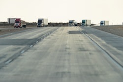Trucks On Highway With Pavement In View