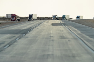 Trucks On Highway With Pavement In View