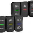 Vehicle control panel with black rocker switches and colored indicator lights