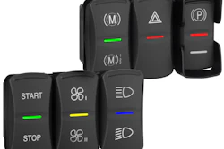 Vehicle control panel with black rocker switches and colored indicator lights