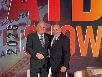 New ATD Chairman Kevin Holmes (left) takes the gavel from prior Chairman Scott Pearson during a general session at the 2026 ATD Show Thursday in Las Vegas.