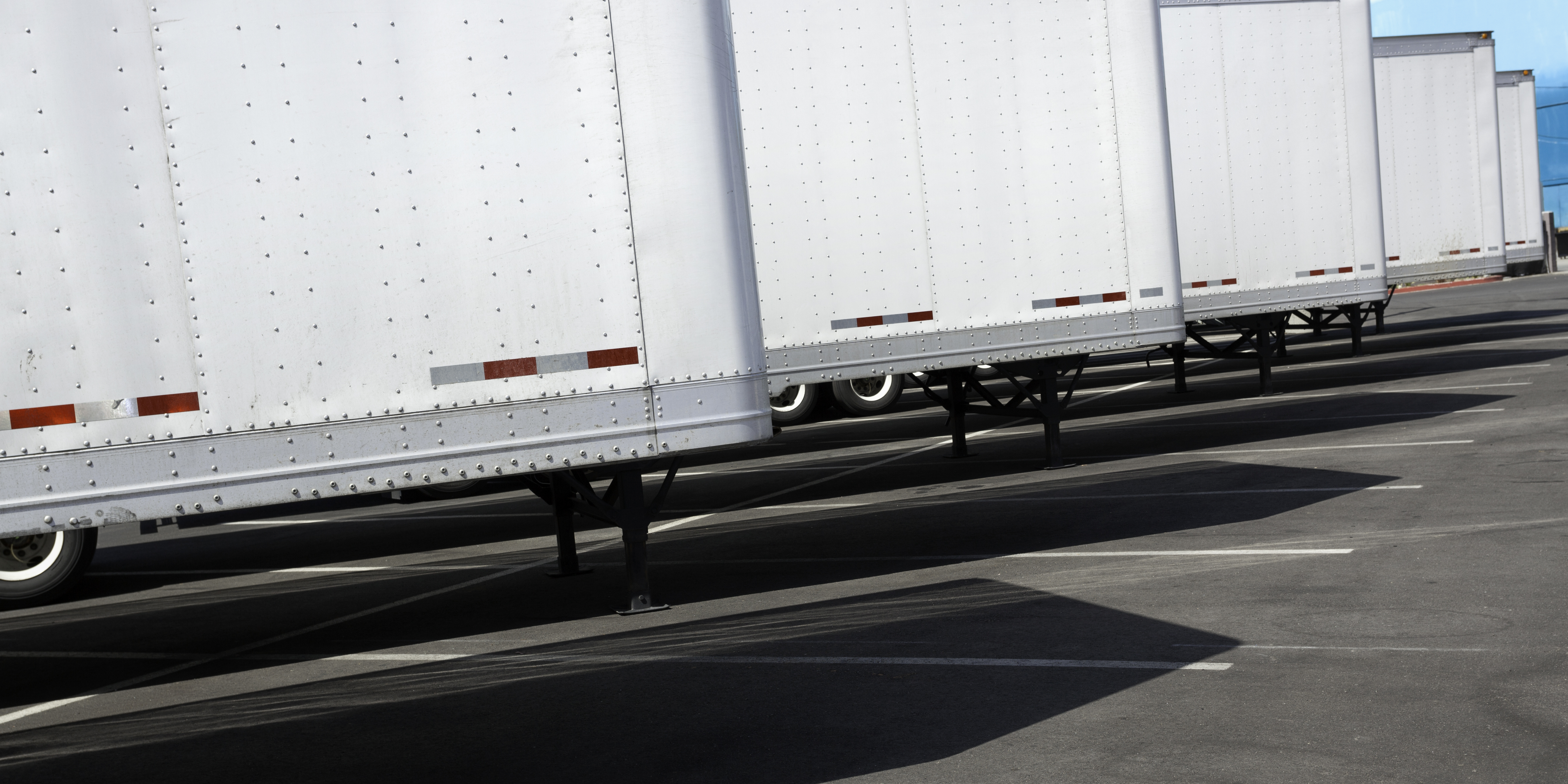 Row Of New White Trailers In Parking Lot