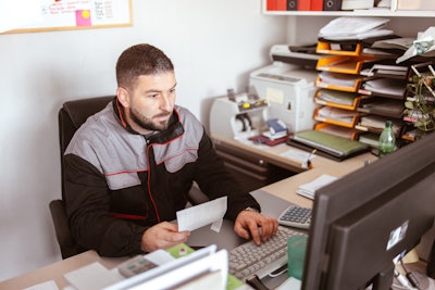 Technician Sitting At Computer
