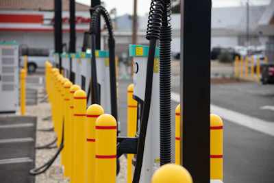 A row of battery-electric commercial vehicle charging stations at EV Realty's San Bernardino, California hub.