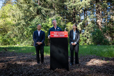 California Governor Gavin Newsom (center) announces the state's lawsuit against the Trump administration and the EPA over its repeal of the Endangerment Finding.