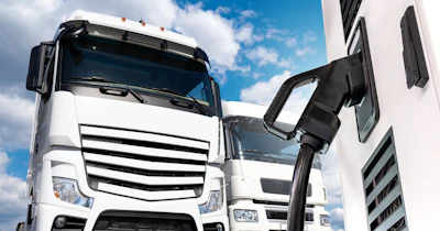 A rendering of a commercial semi-truck connected to a charging cable.