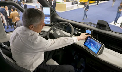 Jones is pictured in the driver's seat here pointing out a display on the dash showing tire pressures delivered in-cab from monitors.