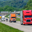 Several Trucks On Highway With Traffic