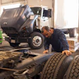 Technician Looking At Tires