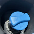 Blue DEF cap on diesel vehicle fuel tank opening