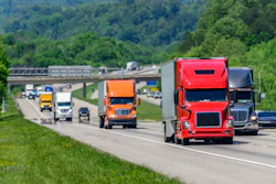 Several Trucks On Highway With Traffic