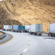 Four Trucks And Trailers On A Highway