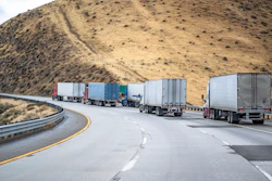 Four Trucks And Trailers On A Highway