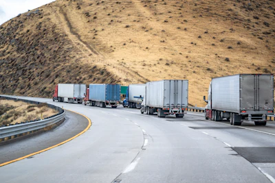 Four Trucks And Trailers On A Highway