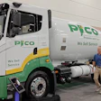 PICO propane delivery truck with green and white branding displaying 'We Sell Service' text at an indoor facility.