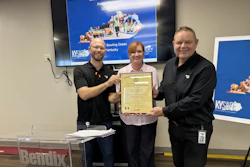 Three professionals holding a framed certificate at a Governors Safety & Health awards ceremony in Bowling Green, Kentucky