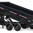Black tandem axle dump trailer with red and white reflective striping and hydraulic lift mechanism