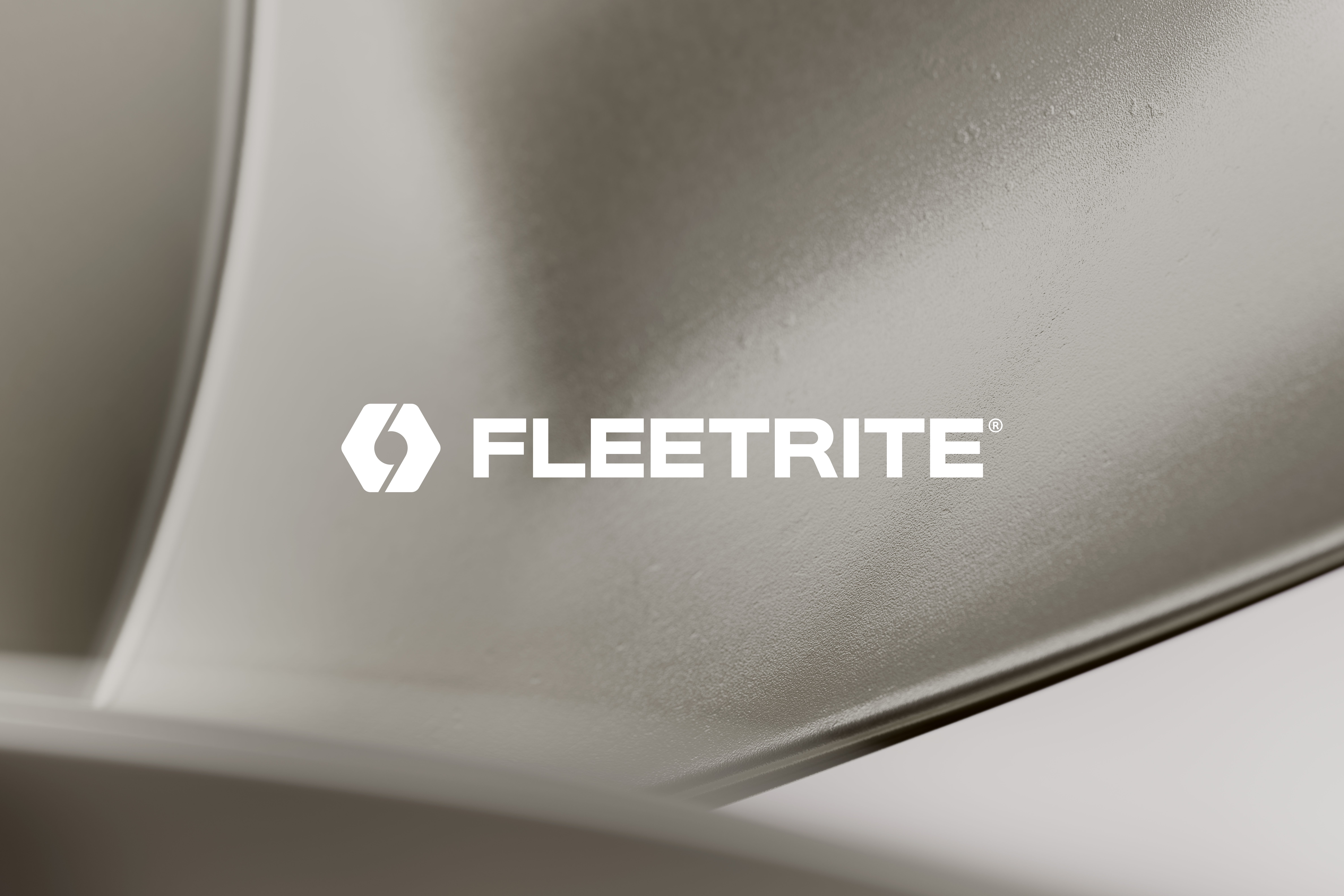 Fleetrite logo on metallic vehicle component surface
