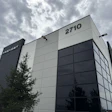 Modern industrial building with Prevost company signage and address 2710 under cloudy sky