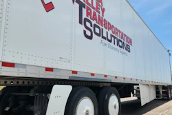 Bella Valley Transportation Solutions semi-truck trailer with red and blue branding and fuel economy tagline