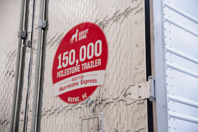 Red circular milestone badge on trailer reading '150,000 Milestone Trailer Built for Hurricane Express' from Wayne, Nebraska