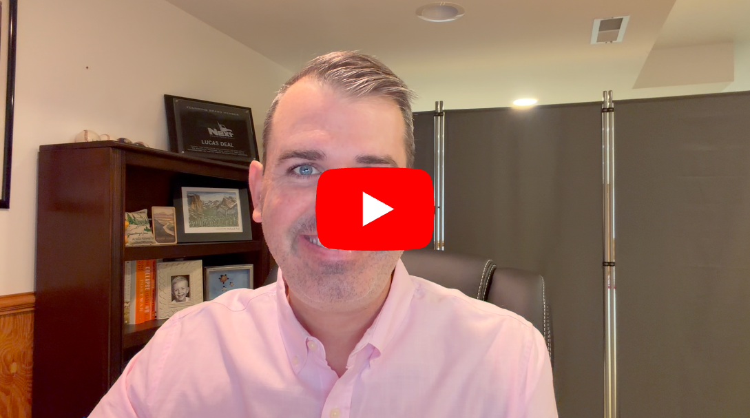 Man in pink shirt during video call with YouTube play button overlay on face