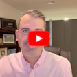 Man in pink shirt during video call with YouTube play button overlay on face