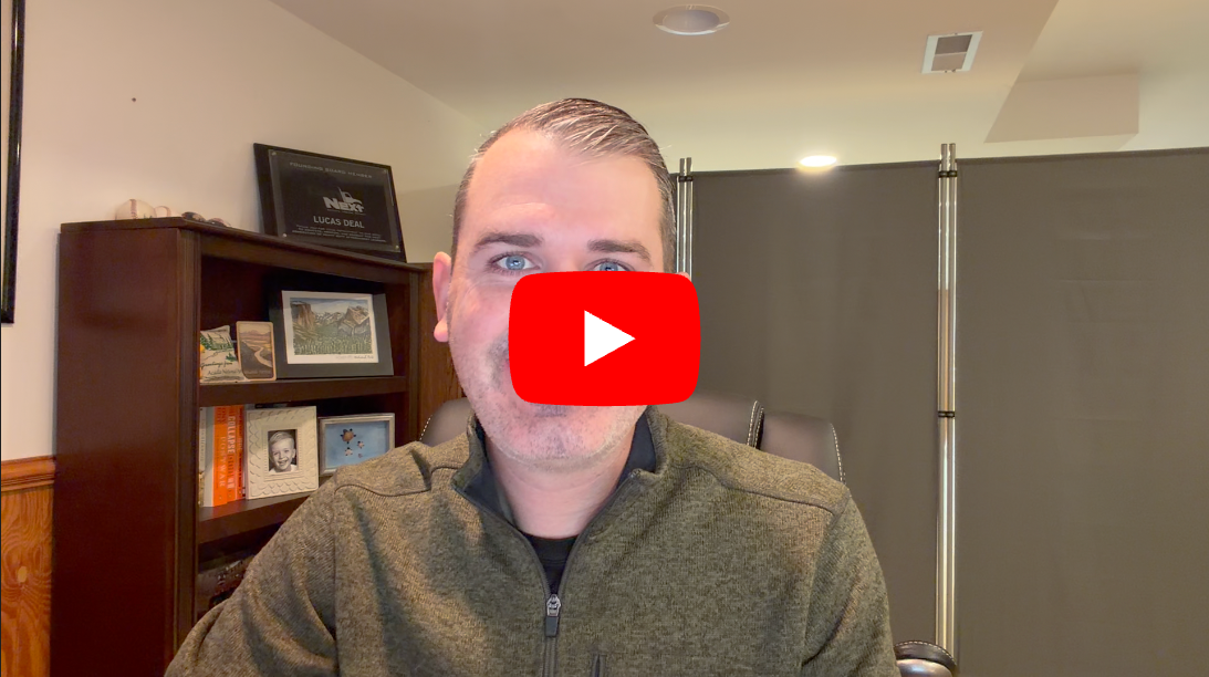 Person in olive jacket with YouTube play button overlay in home office setting