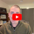 Person in olive jacket with YouTube play button overlay in home office setting