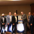 Group of seven men presenting an award during the Successful Dealer Award Summit