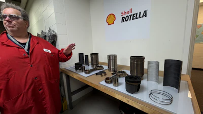 Shell Rotella product display with industrial lubricant samples and containers on table