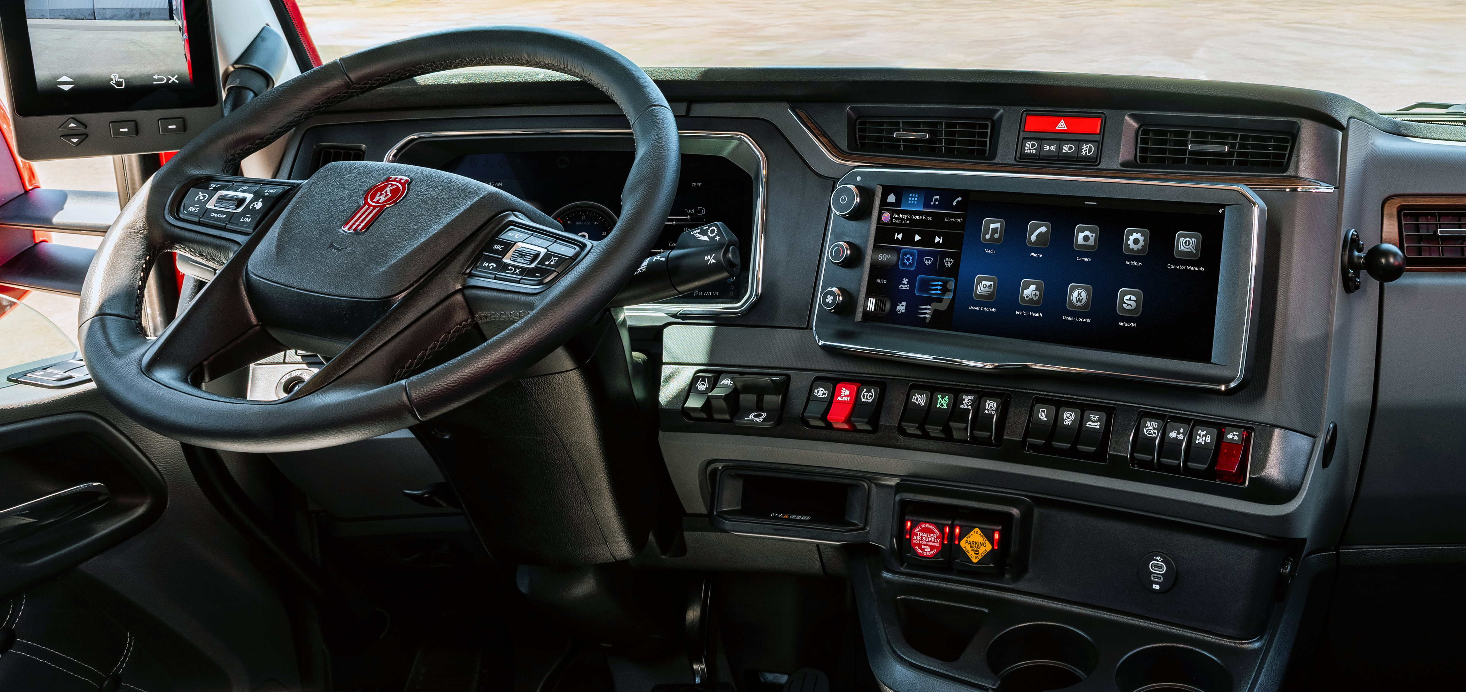 GMC truck interior dashboard with steering wheel, digital display panel, and control buttons