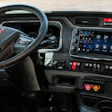 GMC truck interior dashboard with steering wheel, digital display panel, and control buttons
