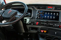 GMC truck interior dashboard with steering wheel, digital display panel, and control buttons