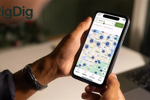 Person holding smartphone displaying RigDig map application with location markers and search interface